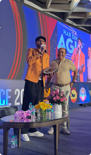 Man holding a mic on stage at an event